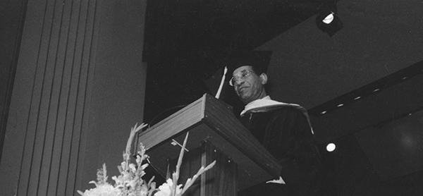 man at graduation lectern